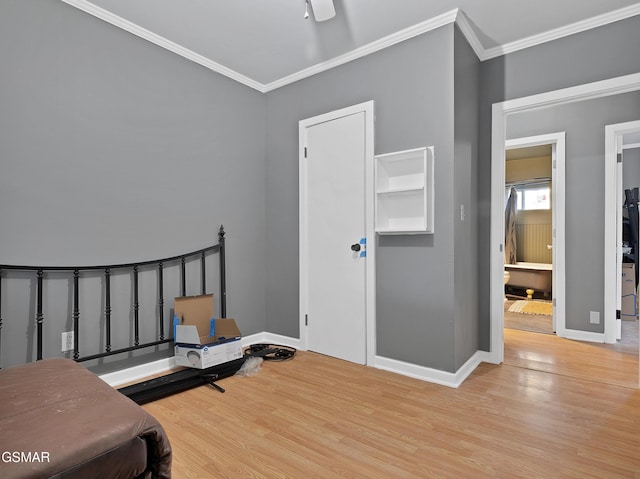 bedroom with crown molding and light hardwood / wood-style flooring