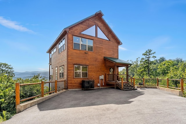 back of property featuring a mountain view