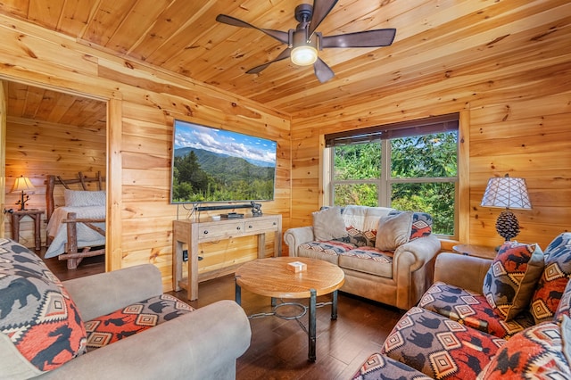 living room with wood ceiling, wood walls, ceiling fan, and dark wood-type flooring