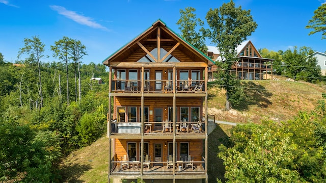 back of property featuring a balcony