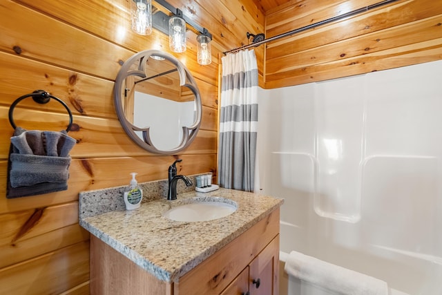 bathroom with a shower with curtain, wood walls, and vanity