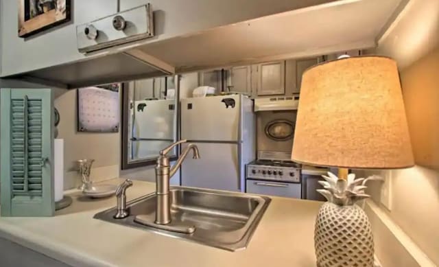 kitchen with white appliances and sink