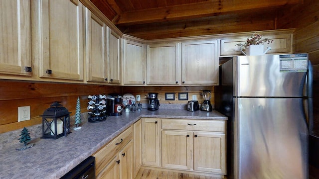 kitchen featuring light brown cabinets, beamed ceiling, stainless steel fridge, wood walls, and light hardwood / wood-style floors