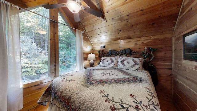 bedroom with ceiling fan, wood walls, wood ceiling, and lofted ceiling