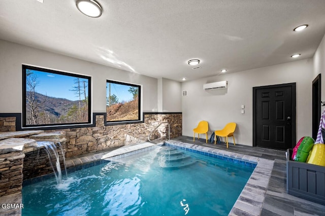 view of pool featuring pool water feature, a mountain view, and a wall unit AC