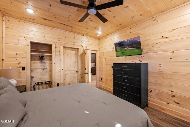 bedroom featuring wood ceiling and wood walls