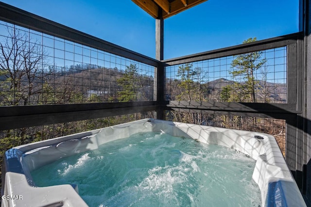 view of pool with a hot tub