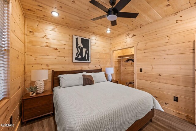 bedroom with wood-type flooring, wooden ceiling, and wooden walls