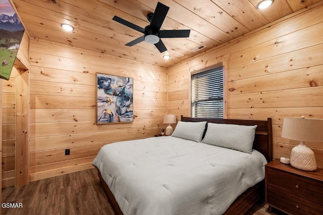 bedroom featuring wooden walls, dark hardwood / wood-style flooring, and wooden ceiling