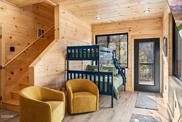 bedroom featuring dark hardwood / wood-style flooring, wood ceiling, and wood walls