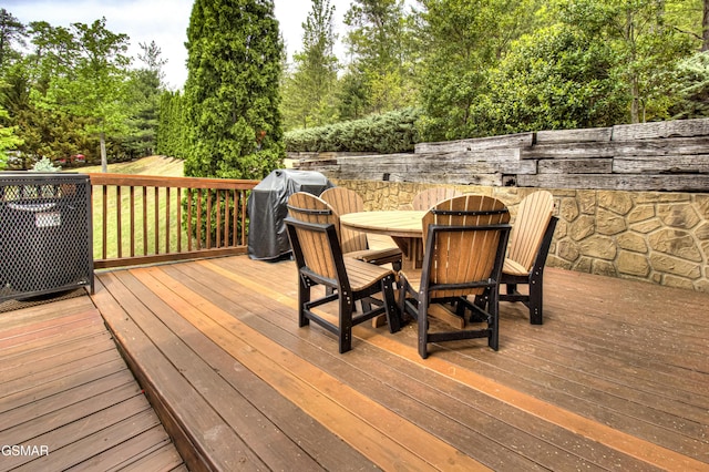deck featuring outdoor dining area and area for grilling
