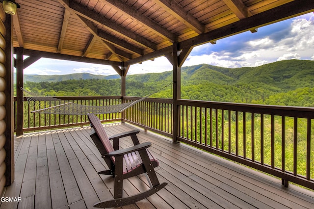 deck with a view of trees and a mountain view
