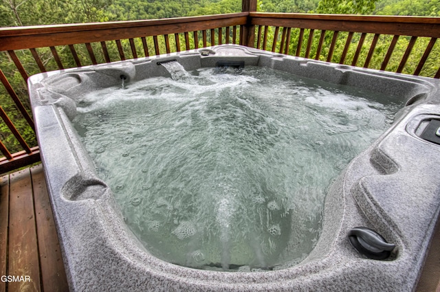 wooden terrace with an outdoor hot tub