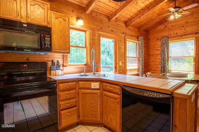 3637 Marshall Ln, Sevierville, TN 37862 - kitchen featuring black appliances, tile counters, light tile patterned flooring, wooden ceiling, and wooden walls