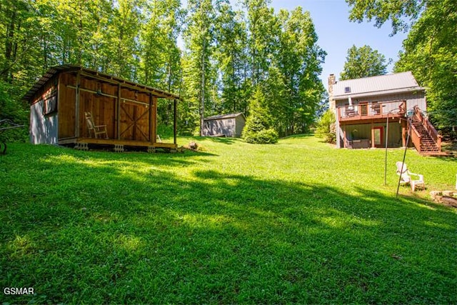 3637 Marshall Ln, Sevierville, TN 37862 - view of grassy yard with stairs, a wooden deck, and a storage shed
