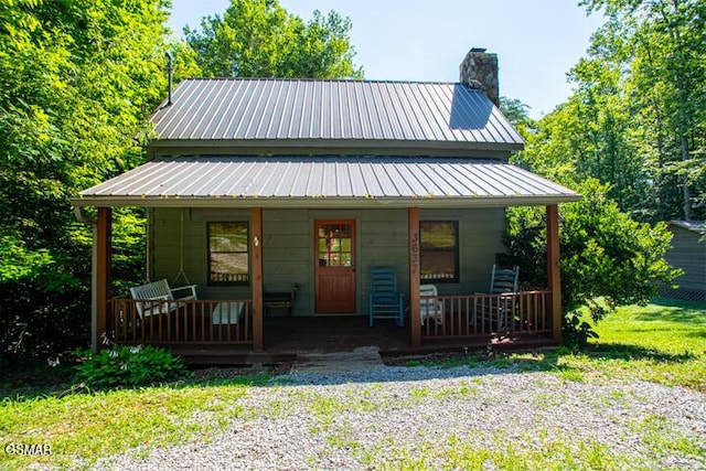 3637 Marshall Ln, Sevierville, TN 37862 - view of front of home featuring covered porch, a chimney, and a metal roof