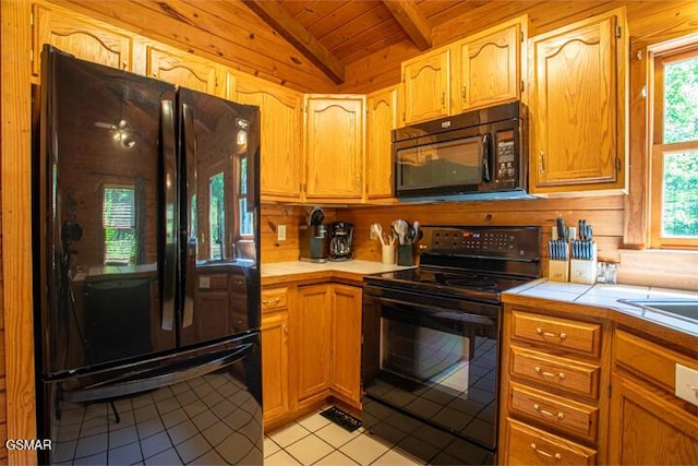 3637 Marshall Ln, Sevierville, TN 37862 - kitchen with black appliances, tile countertops, light tile patterned flooring, wood ceiling, and wood walls
