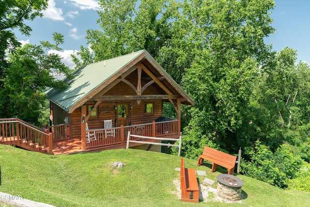 2494 Black Bear Ridge Way, Sevierville, TN 37862 - log-style house with an outdoor fire pit, a front yard, a metal roof, and log veneer siding