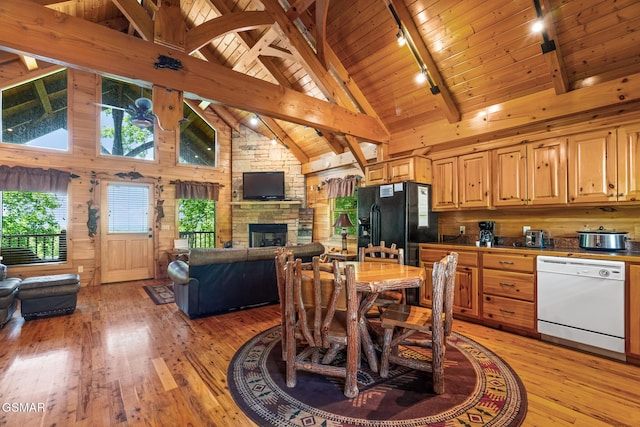 2494 Black Bear Ridge Way, Sevierville, TN 37862 - dining area featuring rail lighting, light wood finished floors, high vaulted ceiling, a fireplace, and a wooden ceiling with exposed beams