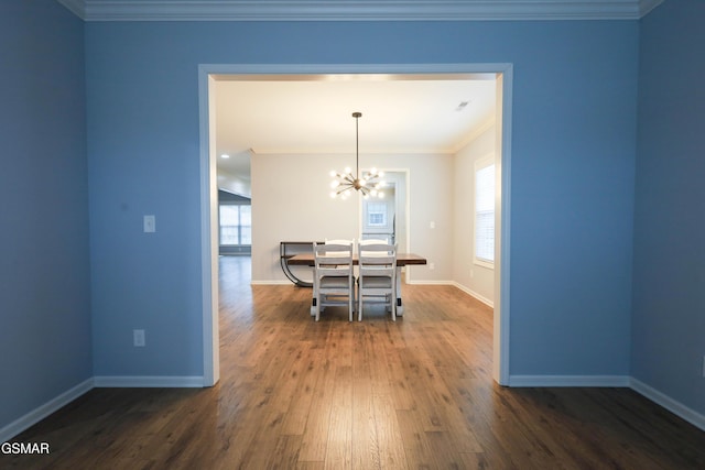 dining space with ornamental molding, dark hardwood / wood-style floors, and a notable chandelier