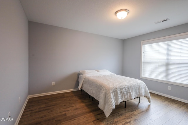 bedroom featuring dark hardwood / wood-style flooring