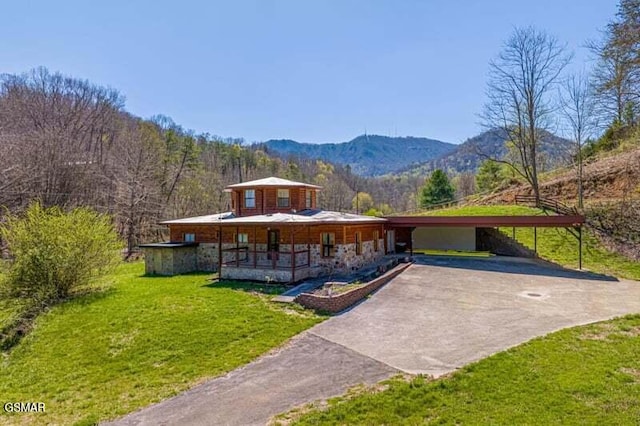 view of front facade with a porch, a mountain view, and a front yard