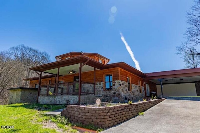 exterior space with a carport and ceiling fan