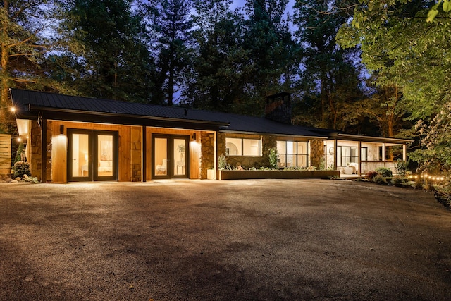 1008 Glades Rd, Gatlinburg, TN 37738 - view of front of property featuring french doors, a chimney, stone siding, and driveway