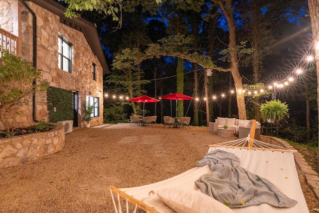 1008 Glades Rd, Gatlinburg, TN 37738 - yard at night with outdoor lounge area and a patio area