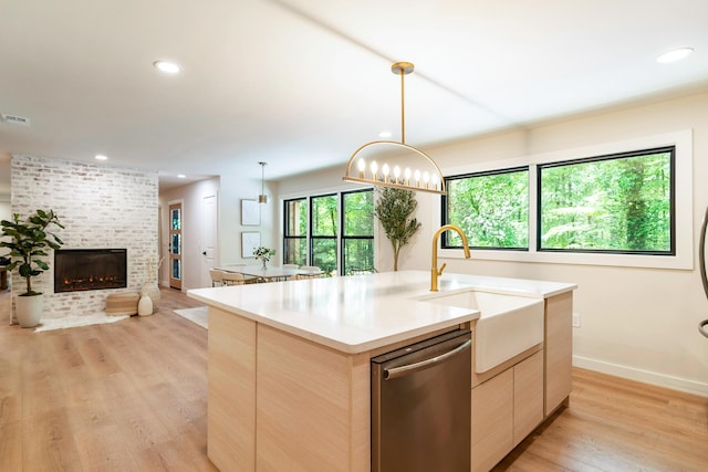 1008 Glades Rd, Gatlinburg, TN 37738 - kitchen with stainless steel dishwasher, a sink, light wood-type flooring, light brown cabinets, and open floor plan