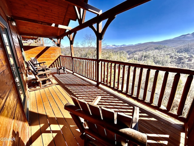 wooden deck with a mountain view