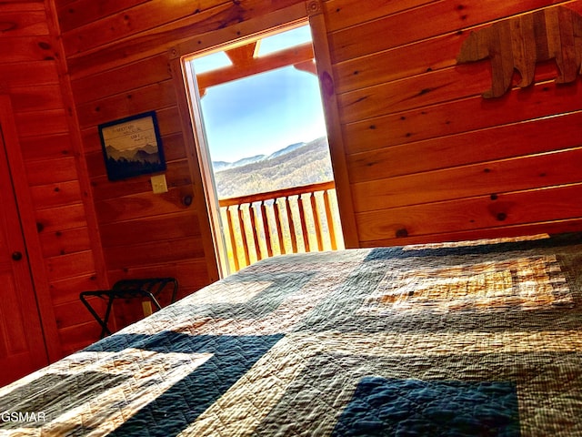 bedroom with a mountain view and wooden walls