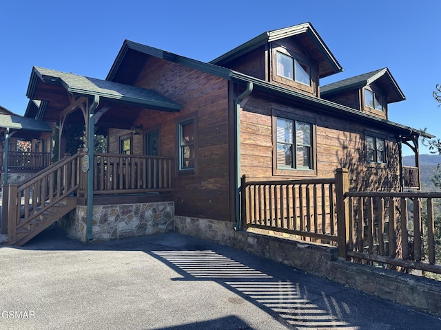 view of side of home with a porch