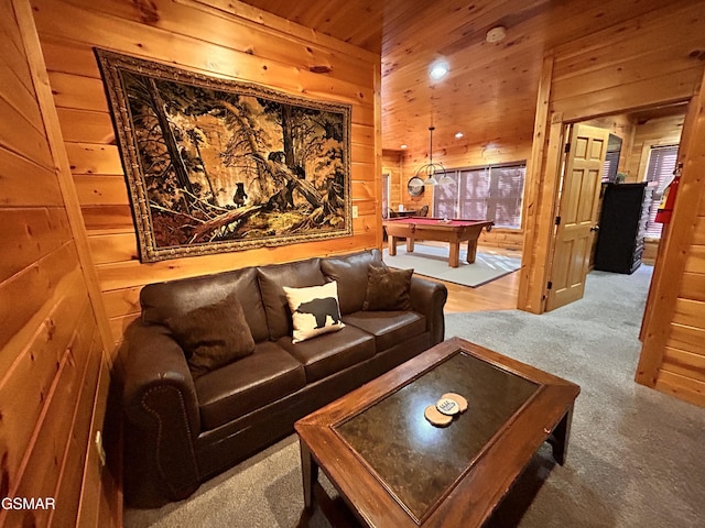 living room with carpet flooring, wood walls, and pool table