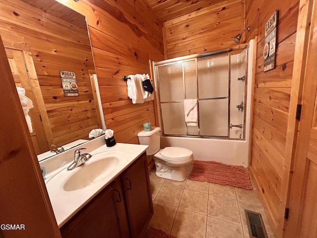 full bathroom featuring tile patterned floors, wood ceiling, vanity, shower / bath combination with glass door, and wood walls