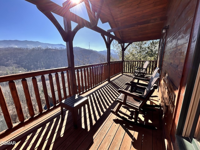 wooden deck with a mountain view