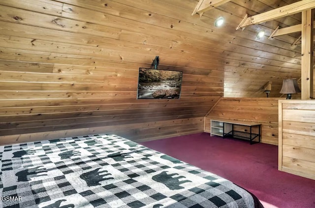 unfurnished bedroom with lofted ceiling with beams, wooden ceiling, dark carpet, and wooden walls