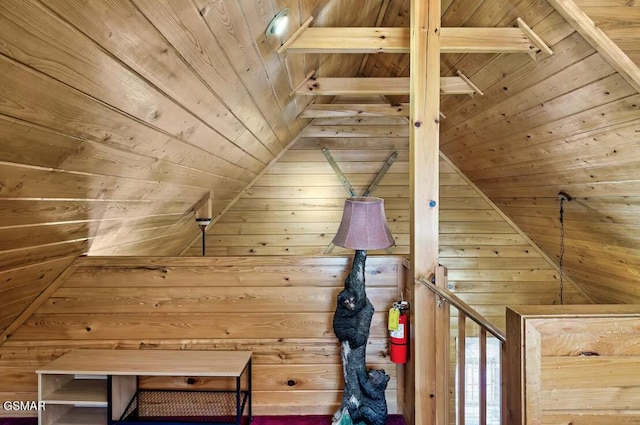 bonus room with wooden walls and wood ceiling