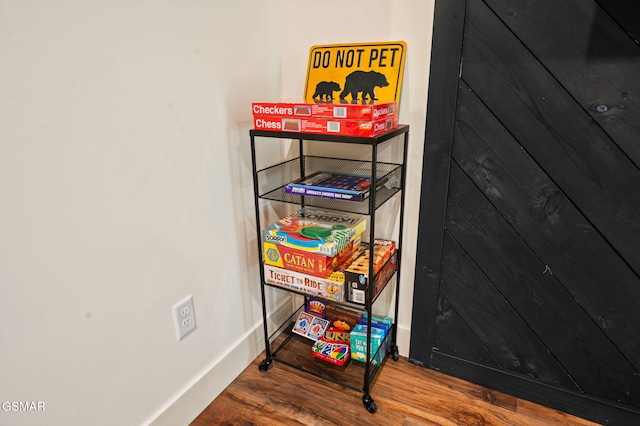 interior details with baseboards and wood finished floors