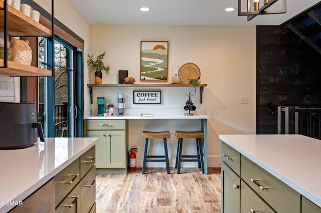 kitchen featuring light wood-style floors, recessed lighting, green cabinetry, and open shelves