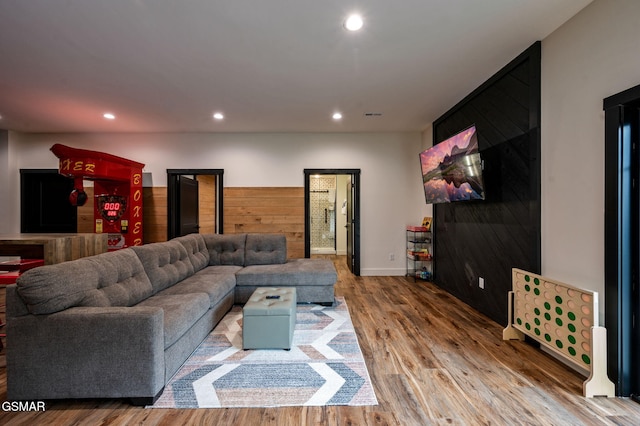 living room featuring recessed lighting, visible vents, wood walls, and wood finished floors