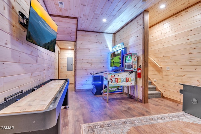 game room featuring wooden ceiling, light wood-type flooring, and wood walls