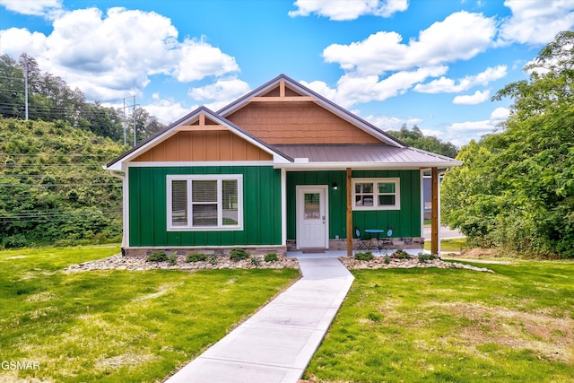 1012 Pinyon Cir, Pigeon Forge, TN 37863 - view of front of house featuring board and batten siding, a porch, a front lawn, and a metal roof