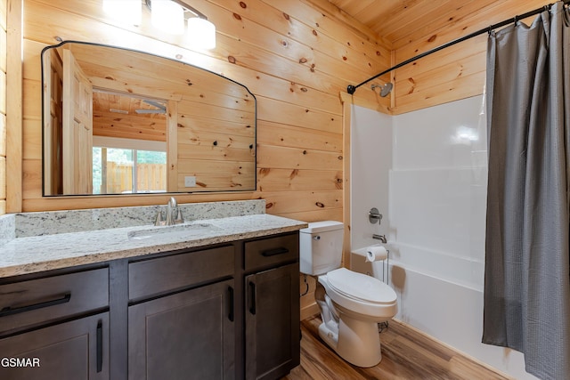 1012 Pinyon Cir, Pigeon Forge, TN 37863 - bathroom with shower / bath combo, wood finished floors, vanity, and wood walls