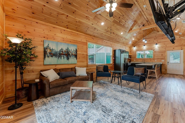 1012 Pinyon Cir, Pigeon Forge, TN 37863 - living area with healthy amount of natural light, wooden walls, a wooden ceiling with exposed beams, light wood-style flooring, and a ceiling fan