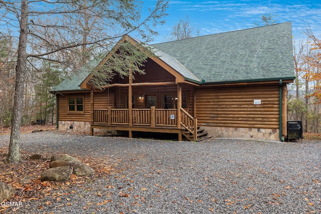 cabin with crawl space, covered porch, and roof with shingles