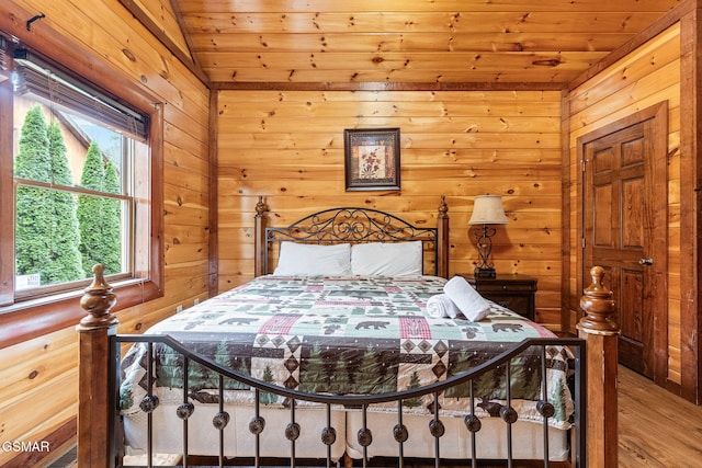 bedroom featuring wooden walls, wood ceiling, and lofted ceiling