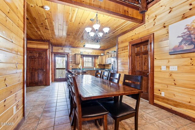 tiled dining space with a chandelier, wooden walls, and wood ceiling