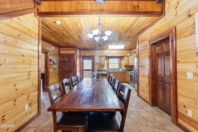 dining space with wooden walls, light tile patterned flooring, wood ceiling, and an inviting chandelier