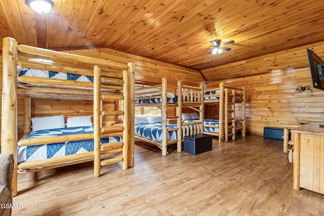 bedroom with wood-type flooring, vaulted ceiling, rustic walls, and wood ceiling